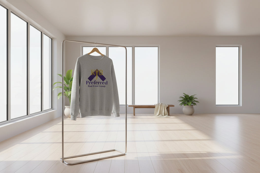 Child wearing a gray sweatshirt with KJB Preferred Real Estate Group logo on a white background